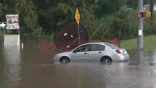 School bus, cars drive through flooded Durham roads