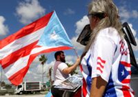 Hundreds mark Hurricane Maria anniversary near Trump resort