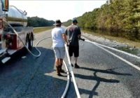 Firefighters wash dead fish from section of I-40 previously flooded by Florence