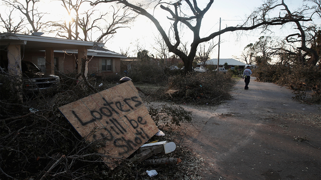 A search and rescue team member walks down a street with homes damaged by Hurricane Michael on October 14, 2018 in Panama City, Florida. (Photo by Scott Olson/Getty Images)