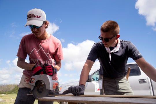 Hudson McLeod, left, 14, of Round Rock, and Marshall Roberts, 19, of Wichita Falls, cut siding on the side of a home that was damaged during Hurricane Harvey in Aransas Pass on Wednesday, July 10, 2019. They were a few of several students from middle school to college who were participating in a BOUNCE mission which offers students an opportunity to help communities dealing with long-term disaster recovery.