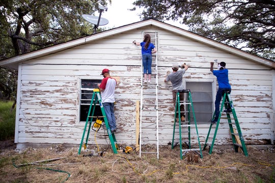 Victor Lopez, from left, of Round Rock, Elli Hoskins, 12, of Plano, David Edward, 12, of Kirbyville, and Landon Carter, 14, of Denton, scrape old paint from a house damaged by Hurricane Harvey in Aransas Pass on Wednesday, July 10, 2019. The students were a few of several students in the area volunteering through BOUNCE, a ministry of Texas Baptists that was launched for students from middle-school to college to help make an impact in communities that have been impacted by disasters.