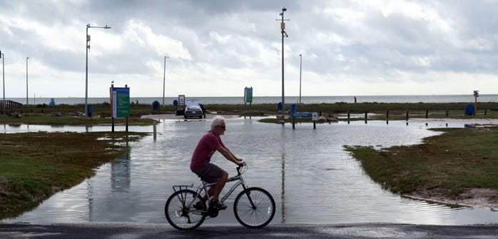 The entrance to Dolphin Park on Sandbar Avenue is flooded with saltwater that baked up through the stormwater pipes after a high tide on Oct. 20.