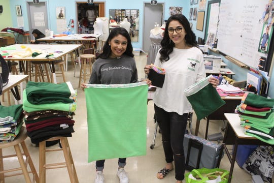 King High School senior council officer Crystal Salazar and student council president Ciara Martinez hold cloth pouches that they helped make, on Friday, Jan. 24, 2020. The pouches will hold marsupials orphaned or displaced by the Australian wildfires and will be donated to a nonprofit called Wildcare Australia.