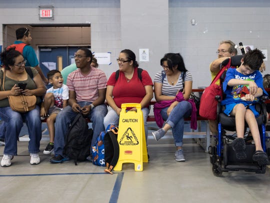 Residents wait inside the Corpus Christi Natatorium to beard a bus to evacuate to San Antonio a head of Hurricane Harvey on Tuesday, Aug. 24, 2017.