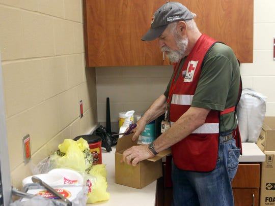 Red Cross Shelter Supervisor Scott Goldsmith opens a box with food and medical aid at the FEMA Dome after Hurricane Harvey displaced families Wednesday, Aug. 30, 2017, at Tulsa-Midway High School in Corpus Christi, Texas. Harvey struck the Texas Coastal Bend as a Category 4 Friday, August 25, 2017.