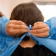 Medical assistant Crystal Gomez puts on PPE before testing patients for coronavirus, Wednesday, June 24, 2020, at the Coastal Bend Wellness Foundation. The clinic provides free testing by appointment to people in the Coastal Bend. 