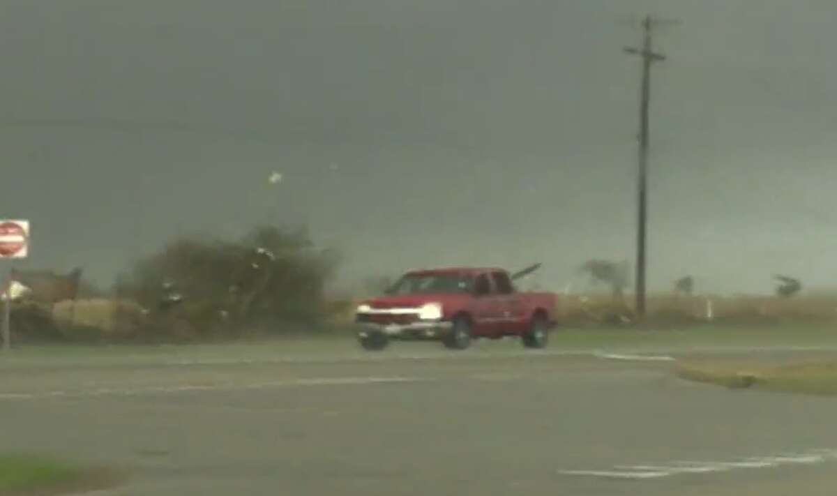 A video uploaded by storm chaser Brian Emfinger shows a red truck getting tossed on its side from tornado winds before driving away. 