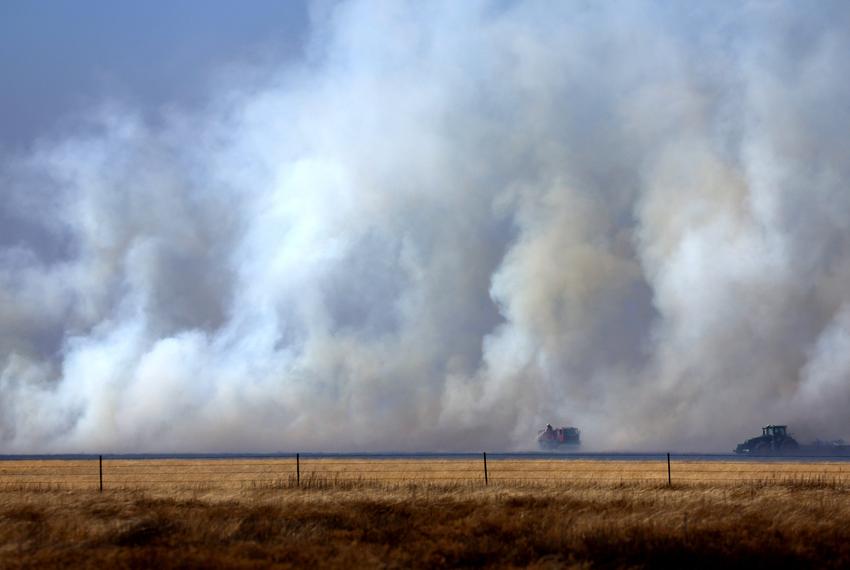 Local firefighters work to contain a wildfire after it was whipped up by high winds in Pampa on March 2, 2024.